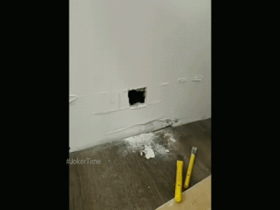 Black paw climbs out of the white wall. It was unexpected.